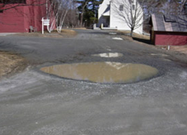 Gravel Lot with Potholes before Driveway Groomer™